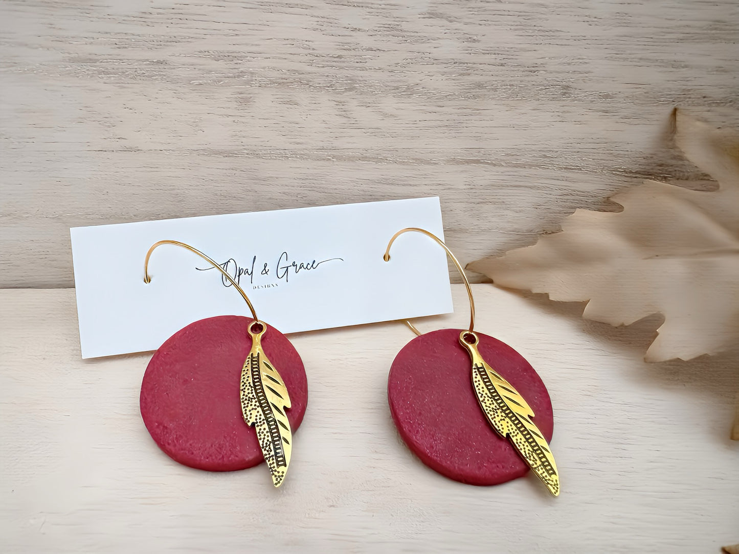 Garnet and gold hoop earring with feather